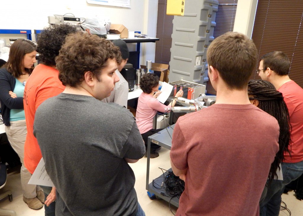 Angela Di Fulvio, CVT Post-Doc Fellow, demonstrates proper calibration to a group of students participating in the Winter 2015 lab.